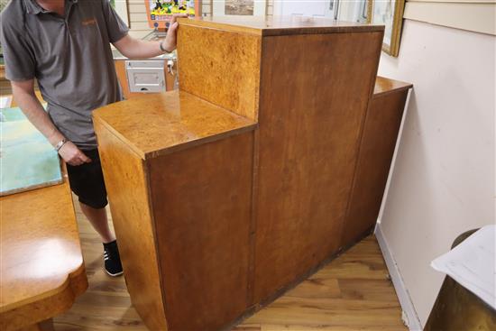 An Art Deco birds eye maple display cabinet and similar dining table,